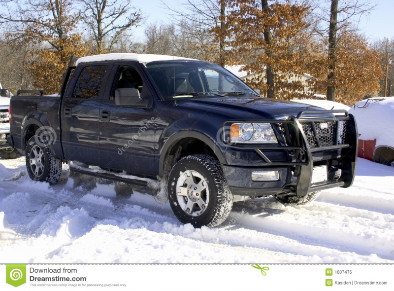 ... Ford F150 four wheel drive truck with grill guard covered in snow and